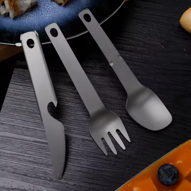 Titanium travel fork set featuring a lightweight, durable fork, knife, and spoon. Perfect for camping, travel, and outdoor dining convenience.